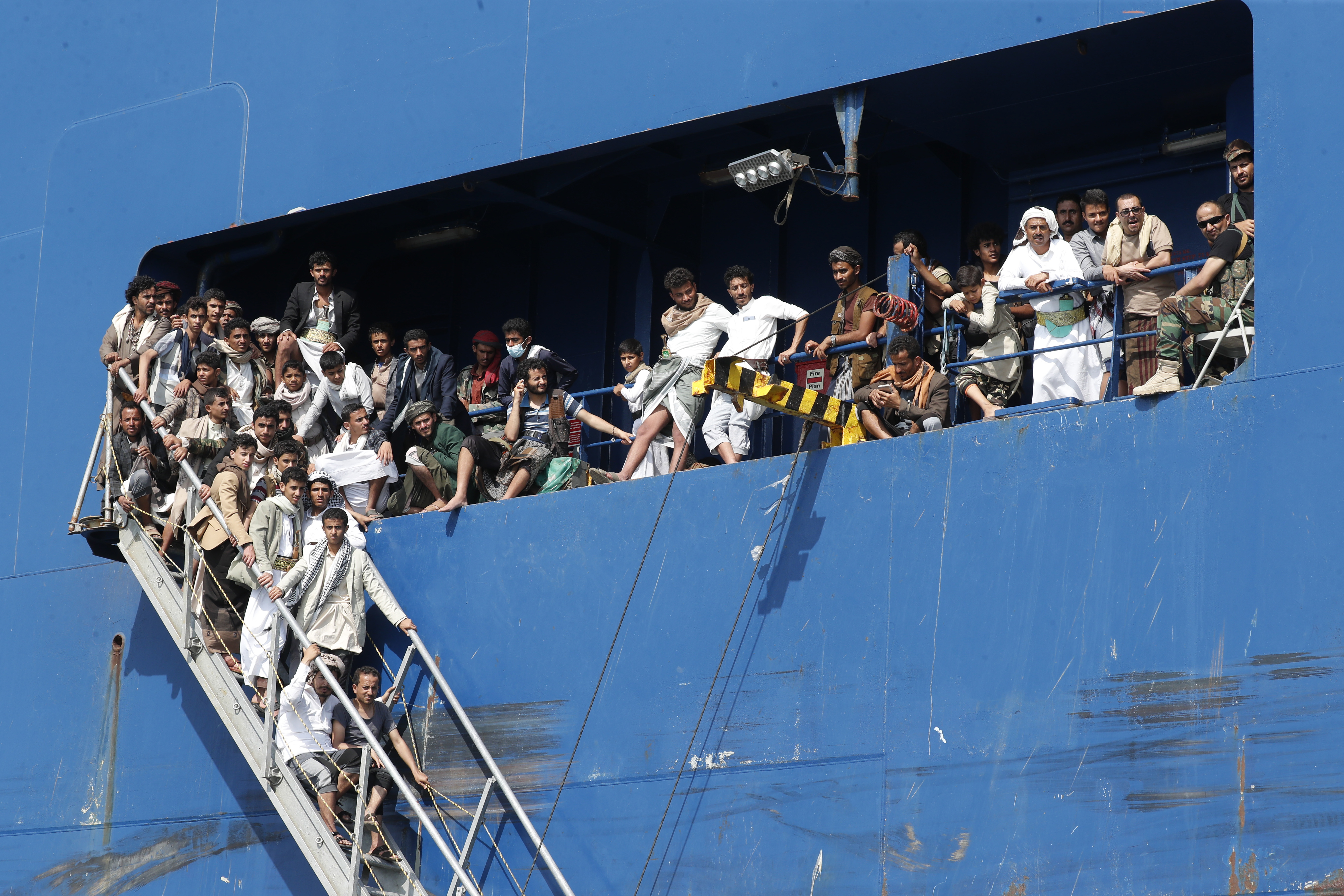 Huge groups of male tourists are seen onboard the captured tanker