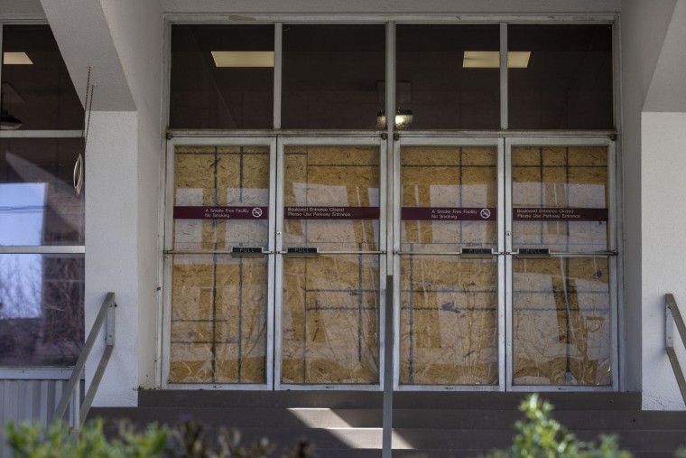 Doors are boarded up to an entrance of the permanently closed Wellstar Health System Atlanta Medical Center