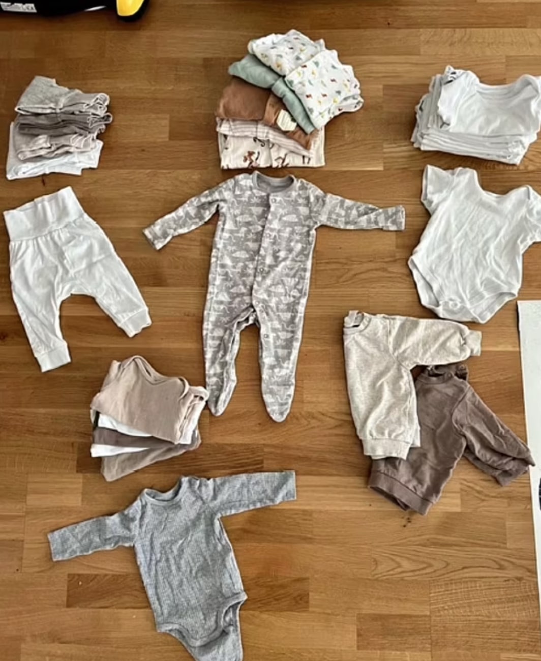 Piles of baby clothes on the bottom of her floor